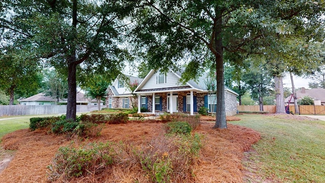 view of front of house with a porch and a front lawn