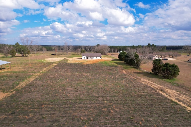 birds eye view of property with a rural view