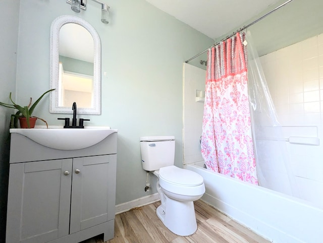 full bathroom with shower / bath combo, vanity, hardwood / wood-style flooring, and toilet