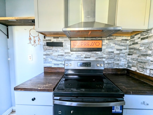 kitchen featuring tasteful backsplash, electric stove, white cabinets, and wall chimney range hood