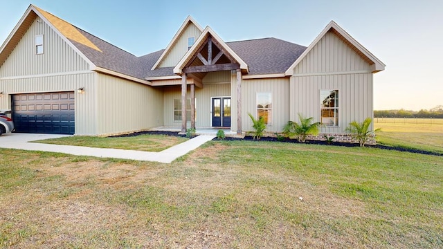 view of front of property featuring a front lawn and a garage