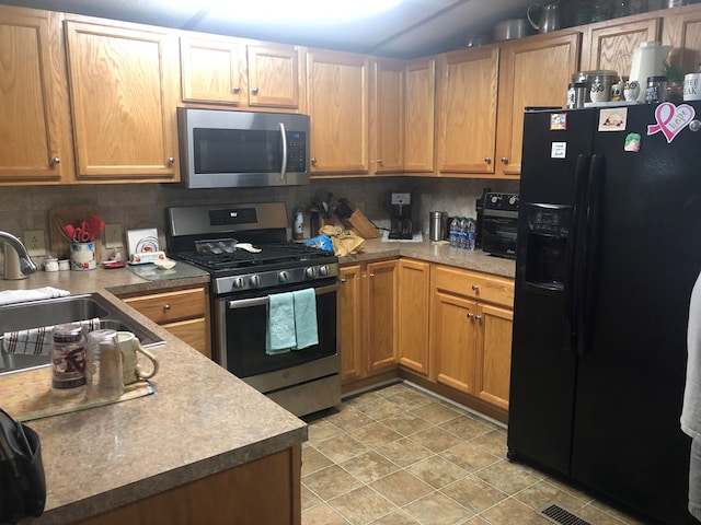 kitchen with decorative backsplash, stainless steel appliances, and a sink
