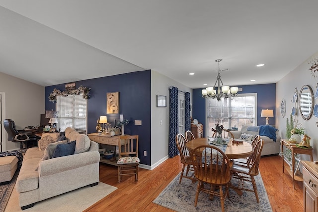 dining room with a notable chandelier and light hardwood / wood-style flooring