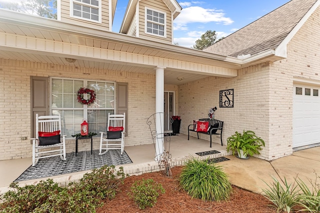 doorway to property featuring a porch and a garage