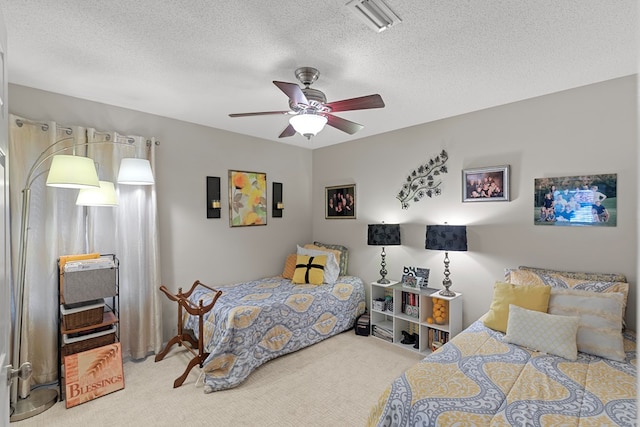 carpeted bedroom featuring a textured ceiling and ceiling fan