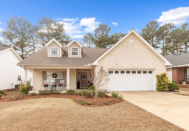 view of front of home featuring covered porch and a garage