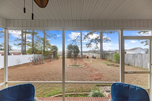 unfurnished sunroom featuring ceiling fan