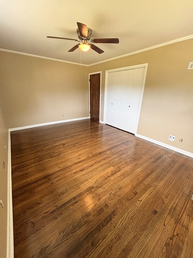 2203 Stonebridge Rd, Dothan, AL 36301 - unfurnished bedroom featuring baseboards, dark wood-type flooring, crown molding, ceiling fan, and a closet
