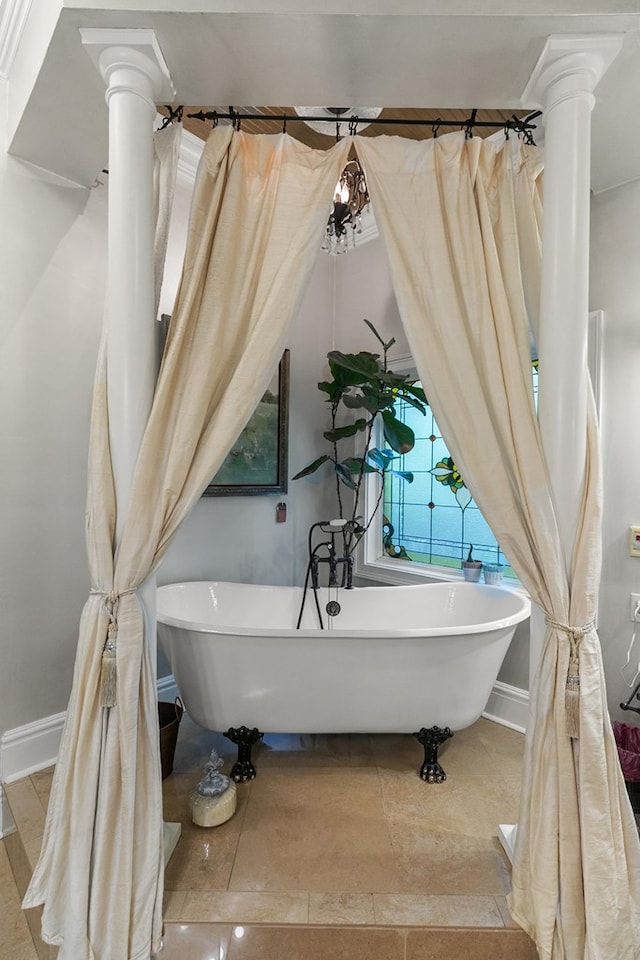 203 Liveoak Trl, Dothan, AL 36305 - full bath featuring ornate columns, a freestanding bath, and baseboards