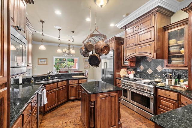 203 Liveoak Trl, Dothan, AL 36305 - kitchen featuring built in appliances, ornamental molding, a sink, wood finished floors, and backsplash