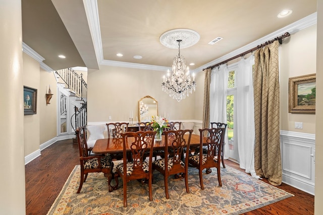 203 Liveoak Trl, Dothan, AL 36305 - dining space featuring crown molding, stairway, dark wood-style flooring, wainscoting, and a chandelier