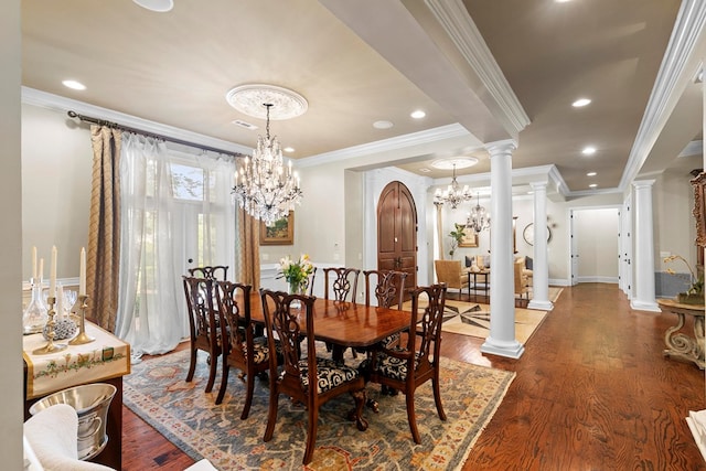 203 Liveoak Trl, Dothan, AL 36305 - dining room with dark wood-style floors, decorative columns, ornamental molding, baseboards, and a chandelier