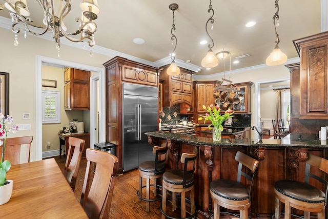 203 Liveoak Trl, Dothan, AL 36305 - kitchen with built in refrigerator, backsplash, crown molding, dark wood finished floors, and recessed lighting