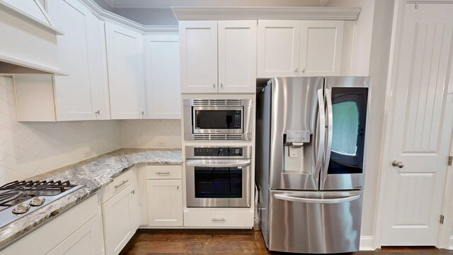 174 Ridgecrest Loop, Dothan, AL 36301 - kitchen with stainless steel appliances, tasteful backsplash, white cabinets, dark wood finished floors, and light stone countertops