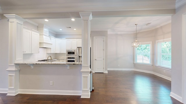 174 Ridgecrest Loop, Dothan, AL 36301 - kitchen with appliances with stainless steel finishes, a peninsula, dark wood-type flooring, light stone countertops, and a kitchen bar