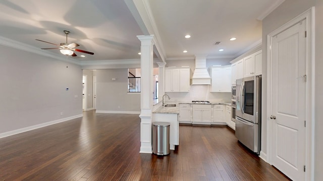 174 Ridgecrest Loop, Dothan, AL 36301 - kitchen with premium range hood, ceiling fan, stainless steel appliances, ornate columns, and ornamental molding