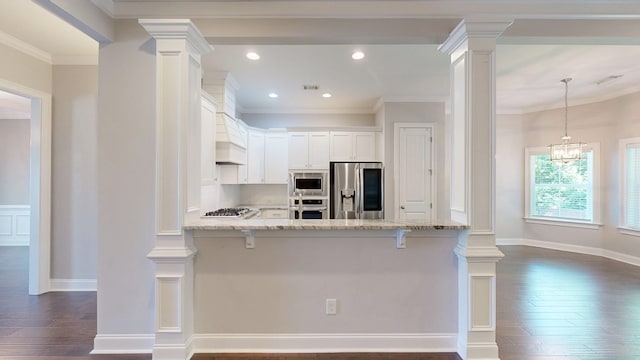 174 Ridgecrest Loop, Dothan, AL 36301 - kitchen with stainless steel appliances, dark wood-style flooring, light stone countertops, ornate columns, and crown molding
