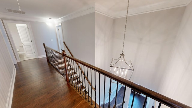 174 Ridgecrest Loop, Dothan, AL 36301 - hallway with an upstairs landing, a chandelier, ornamental molding, dark wood finished floors, and baseboards