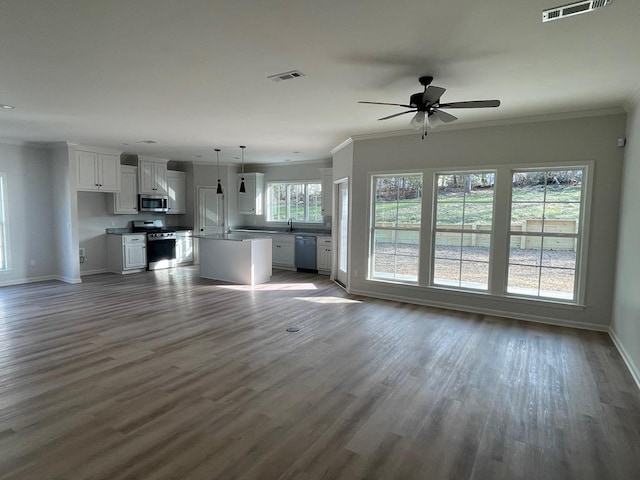 unfurnished living room featuring hardwood / wood-style flooring, ornamental molding, and ceiling fan