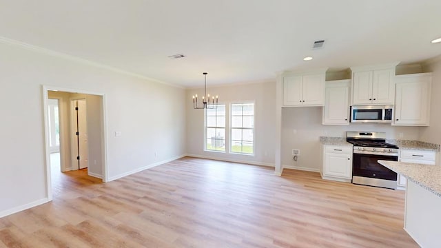 28 Memory Ln, Eufaula, AL 36027 - kitchen featuring appliances with stainless steel finishes, ornamental molding, a chandelier, light wood-type flooring, and white cabinetry