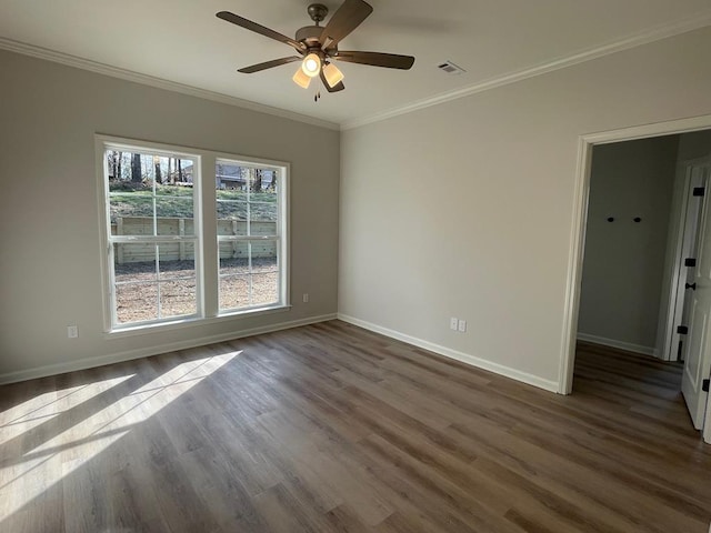 unfurnished room featuring crown molding, dark wood-type flooring, and ceiling fan