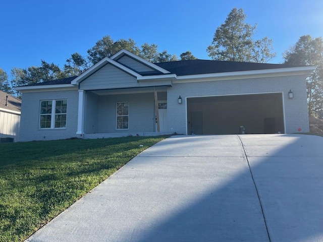 view of front of house with a garage and a front lawn