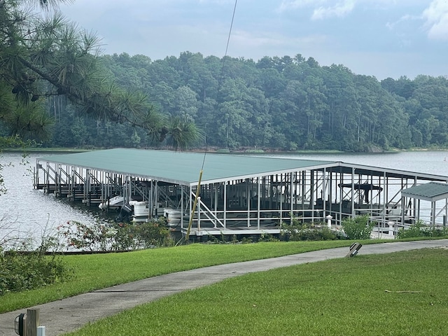 view of dock featuring a water view and a yard