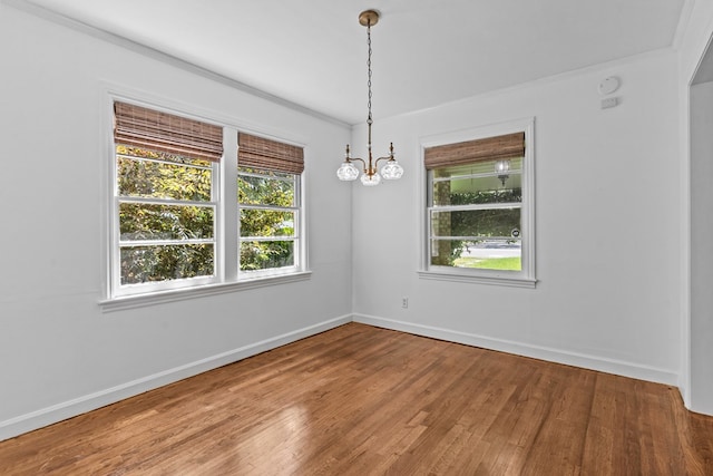 700 S Lakeview, Dothan, AL 36301 - empty room featuring healthy amount of natural light, baseboards, wood finished floors, crown molding, and a chandelier