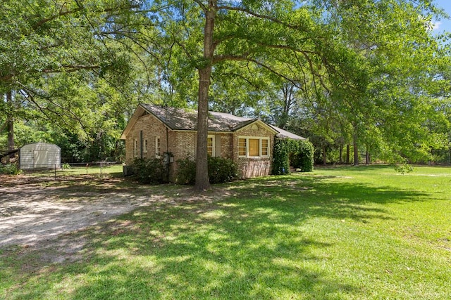 700 S Lakeview, Dothan, AL 36301 - view of home's exterior featuring a shed, brick siding, and an outbuilding