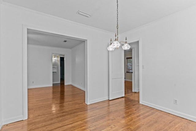 700 S Lakeview, Dothan, AL 36301 - unfurnished room featuring crown molding, light wood-type flooring, a chandelier, and baseboards