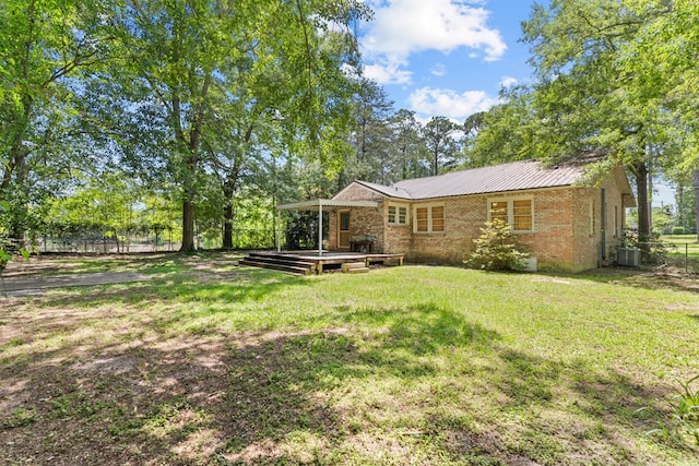 700 S Lakeview, Dothan, AL 36301 - back of house featuring a deck, brick siding, and central AC