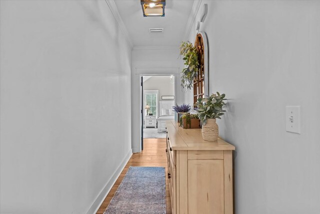 hallway with crown molding and wood-type flooring