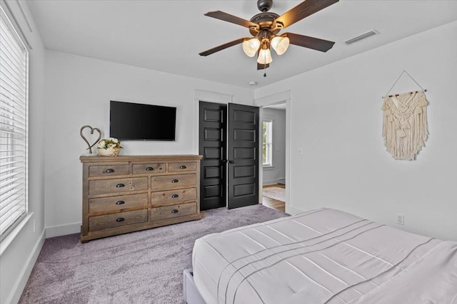 bedroom with light carpet and ceiling fan