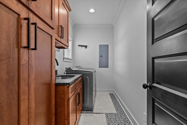 laundry area featuring sink, cabinets, ornamental molding, electric panel, and washing machine and dryer