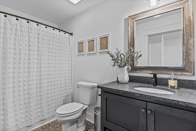 bathroom featuring vanity, curtained shower, and toilet