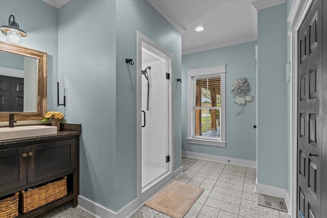 bathroom featuring vanity, crown molding, a shower with door, and tile patterned floors