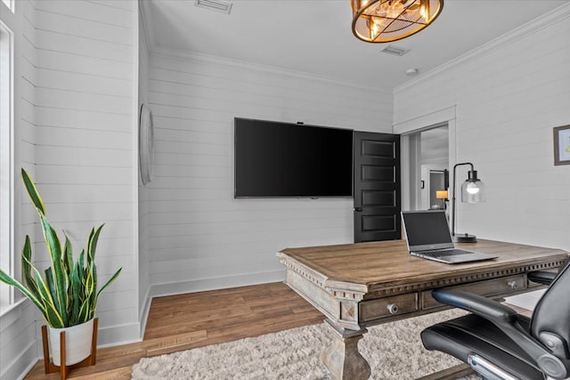 office with ornamental molding and hardwood / wood-style floors