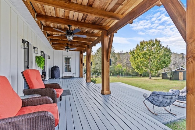 deck with a yard and ceiling fan