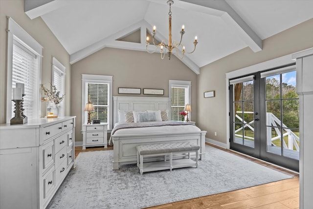 bedroom with light hardwood / wood-style flooring, an inviting chandelier, access to exterior, lofted ceiling with beams, and french doors