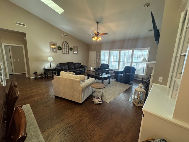 living room with ceiling fan, dark wood-type flooring, and vaulted ceiling