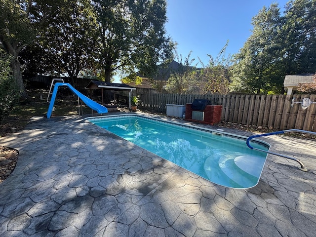 view of pool featuring a gazebo, a patio area, and a water slide