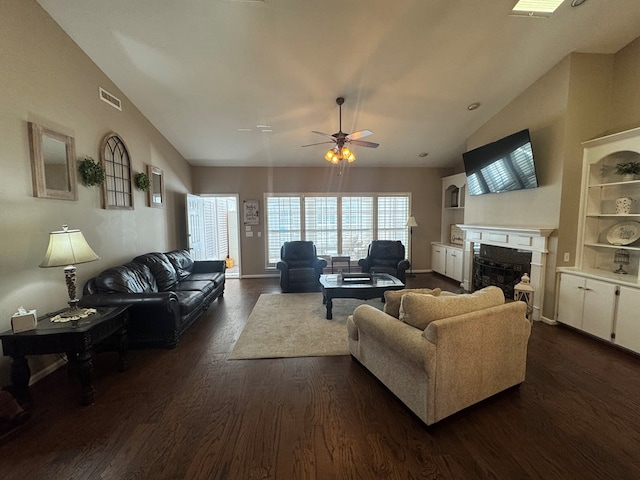 living room featuring dark hardwood / wood-style floors, ceiling fan, built in features, and vaulted ceiling