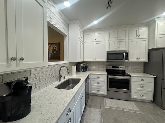 kitchen featuring sink, white cabinets, and appliances with stainless steel finishes