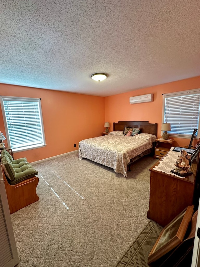 carpeted bedroom with a wall mounted AC, a textured ceiling, and multiple windows