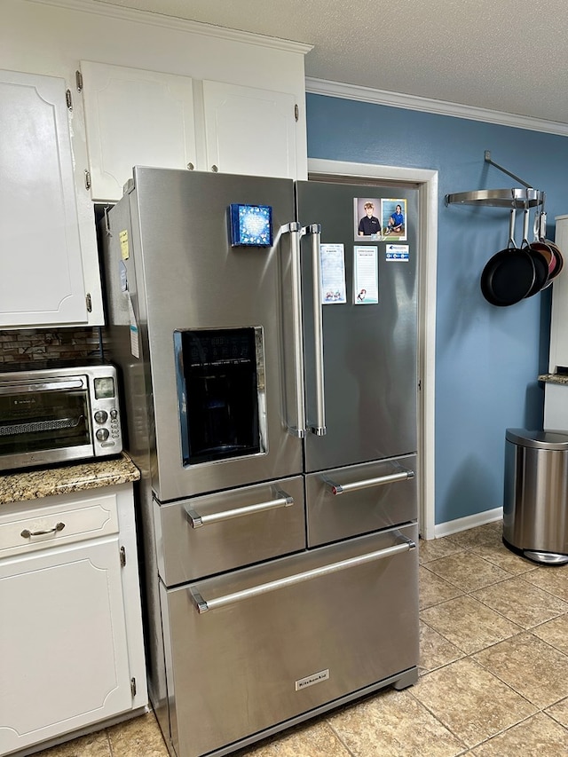 kitchen with white cabinets, stainless steel fridge with ice dispenser, crown molding, and a textured ceiling