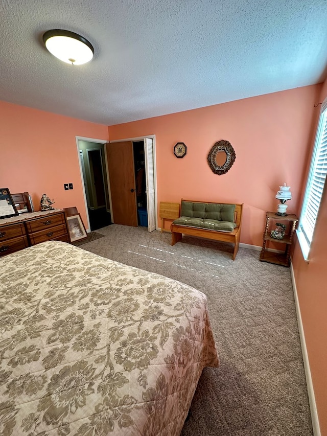 bedroom with a textured ceiling and carpet