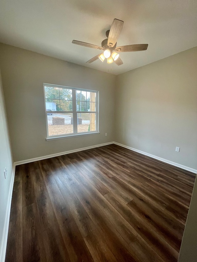 spare room with ceiling fan and dark wood-type flooring