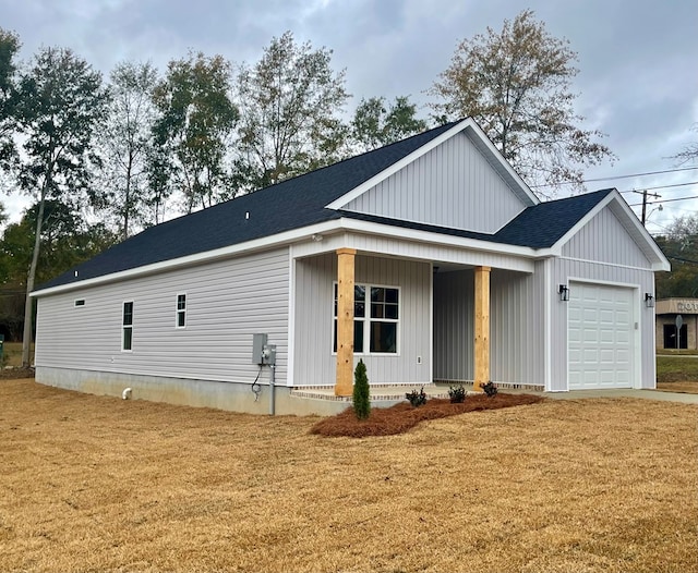 view of front facade featuring covered porch and a garage