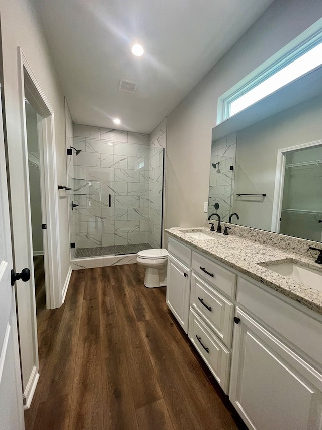 bathroom with vanity, hardwood / wood-style flooring, toilet, and a shower with shower door