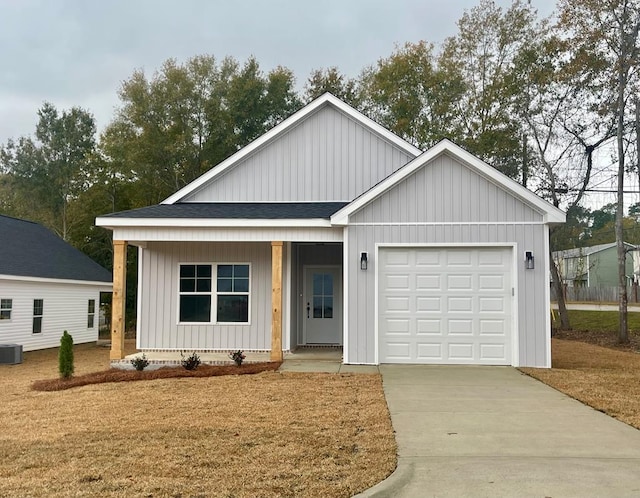 view of front of home featuring central air condition unit and a garage